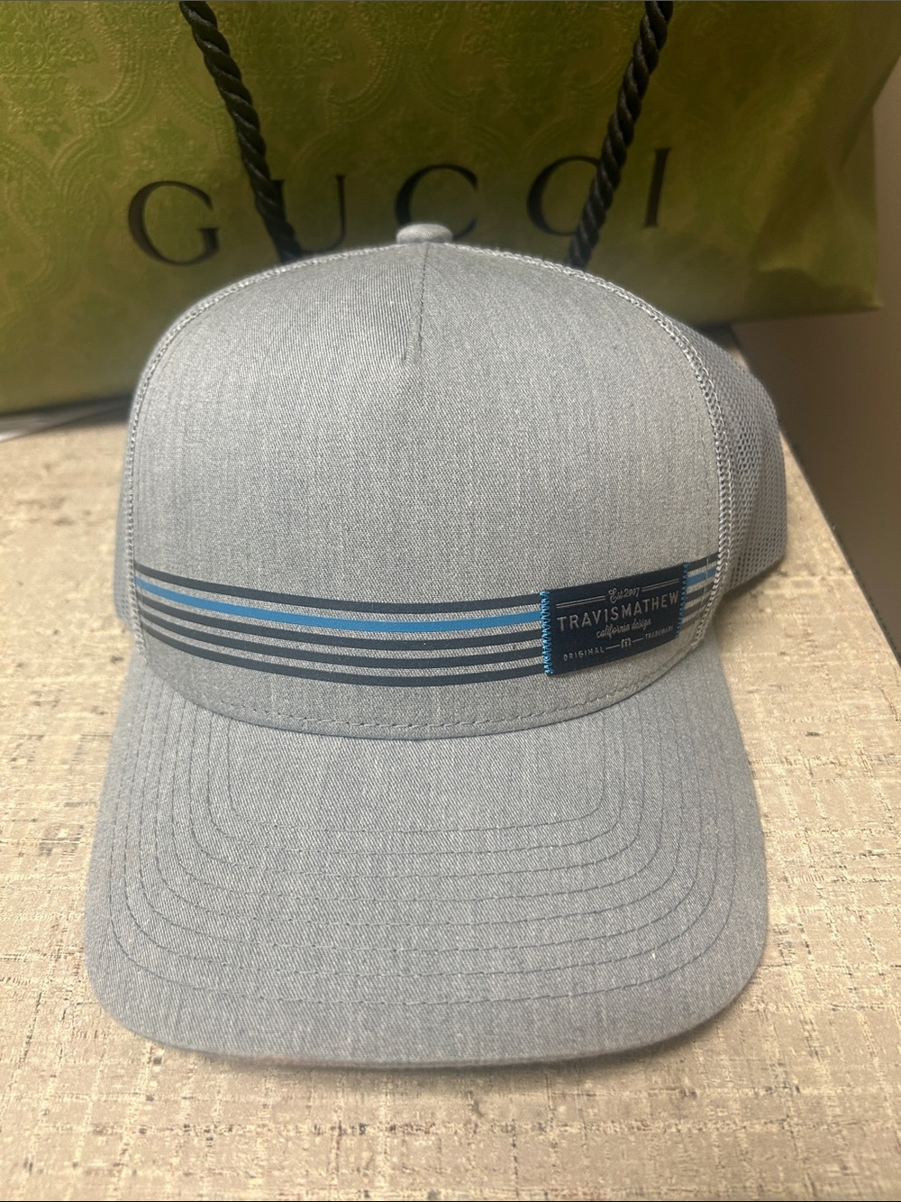 Travis Mathew Light Gray Trucker Hat with Blue Stripe